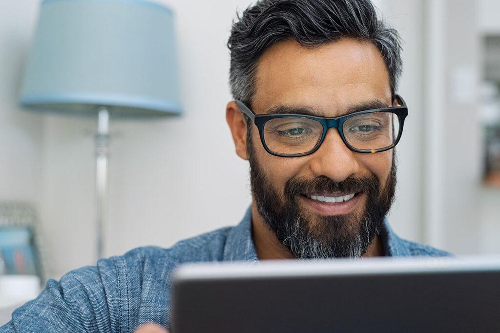 Man smiling looking at iPad