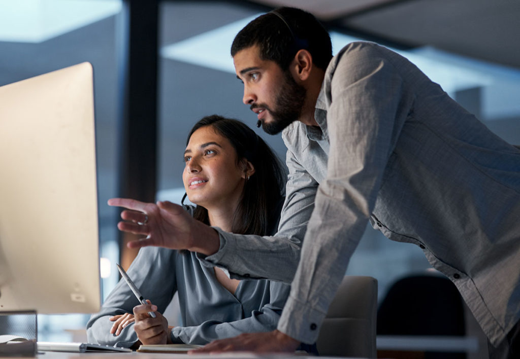 Two people working together on a screen