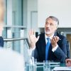 Man in suit speaking at office meeting