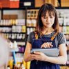 Woman working in shop holding iPad